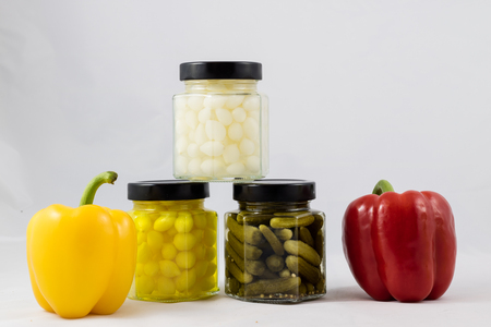 Red and yellow peppers, preserves and olive oil in the pantryの写真素材