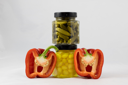 Red and yellow peppers, preserves and olive oil in the pantryの写真素材