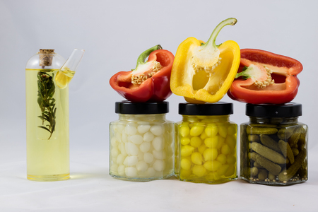 Red and yellow peppers, preserves and olive oil in the pantryの写真素材