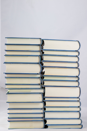 Heap of books on a white isolated background with a nibの写真素材
