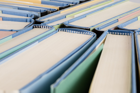 Heap of books on a white isolated background with a nibの写真素材