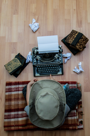 Writer while working on a new wonderful book sitting on the floor