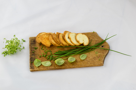 Delicious fresh spring vegetables and toasts for breakfast, white isolated backgroundの写真素材