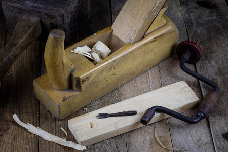 Old carpentry, carpentry workshop, drilling in a piece of wood.の写真素材