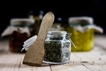 Spice in a jar and preparations on a wooden table, black backgroundの写真素材