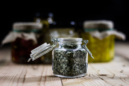 Spice in a jar and preparations on a wooden table, black backgroundの写真素材