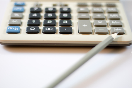 Documents, calculations, calculator, calculator and pen and a pencil on a white backgroundの写真素材
