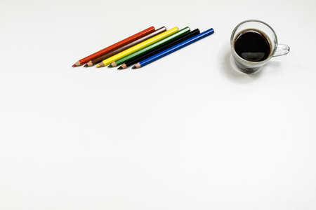 Coffee and sketchbook for drawings. White table. Isolated background. White background.の写真素材
