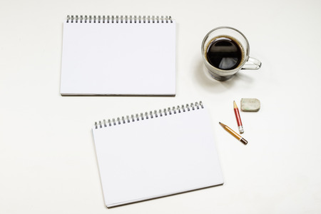 Coffee and sketchbook for drawings. White table. Isolated background. White background.の写真素材