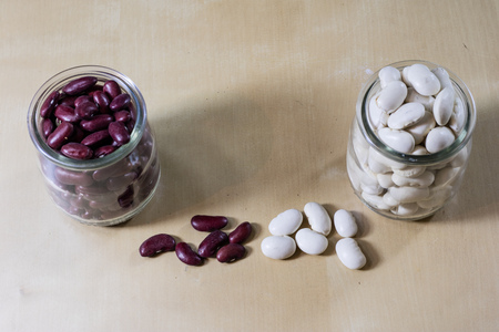 Delicious bean in a glass jar on a wooden kitchen table. Black background.の写真素材