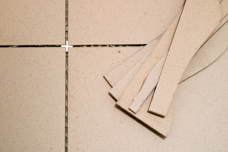 Tiling, tile trimming, metering and cutting. Repair of the floor. Sliced gres tiles. Renovated room.の写真素材