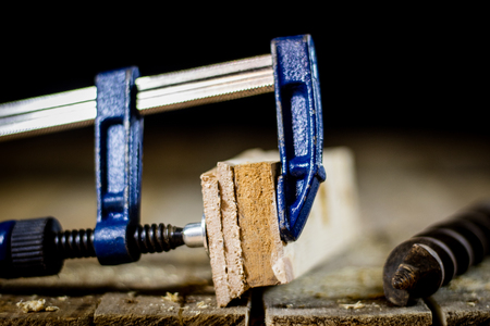 Old good carpentry, tools drill bit. Wooden carpentry table and old good carpentry tools on it. Black background.の写真素材