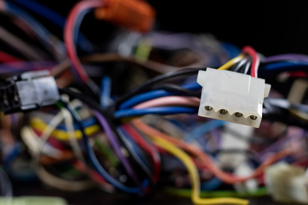 Old entangled cables, electronics and old cable connectors on a black table. Black backgroundの写真素材