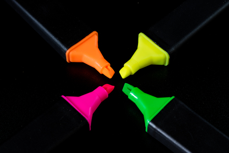 Office Highlighter on a black background. Office Mazak to draw are lying on a black countertop....