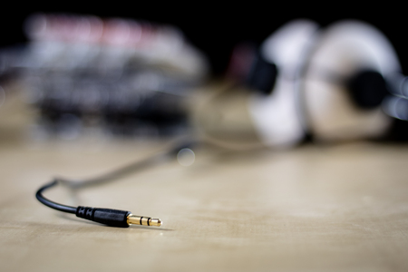 Cassette tape and headphones for listening to music. Old good music from the 80s. Wooden table, black backgroundの写真素材