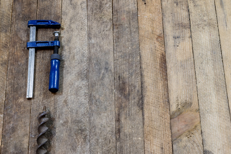 Tools on a wooden table in an old workshop. Arranged on the edge of the table. wooden table, black...