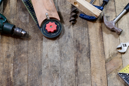 Tools on a wooden table in an old workshop. Arranged on the edge of the table. wooden table, black...