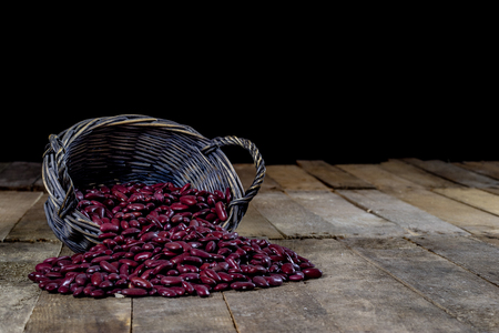 Tasty beans in a basket on a kitchen table. Autumn season. Wooden table, black backgroundの写真素材