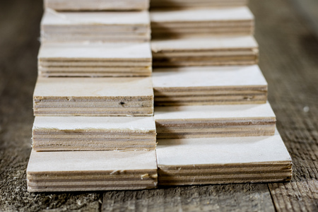Freshly cut plywood. Plywood strips arranged in stacks. Warehouse with plywood. Materials for...
