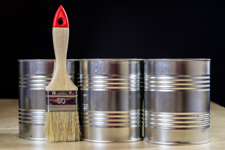 Old paintbrushes for paint, Cans of paint on wooden table. Painting workshop. Black backgroundの写真素材