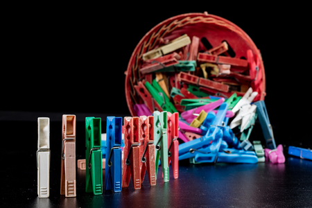 Old plastic buckles on a black countertop. Clipped very worn on a black background. Hanging laundry and laundry.の写真素材