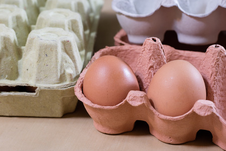 Eggs in molds on a wooden kitchen table. Hen egg in the kitchen atmosphere. black background
