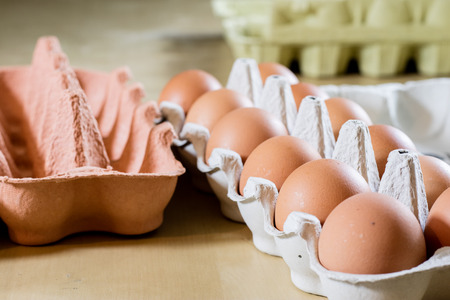 Eggs in molds on a wooden kitchen table. Hen egg in the kitchen atmosphere. black background