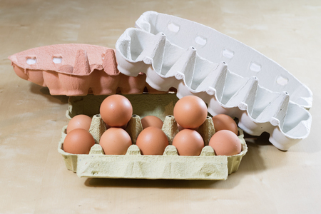 Eggs in molds on a wooden kitchen table. Hen egg in the kitchen atmosphere. black background