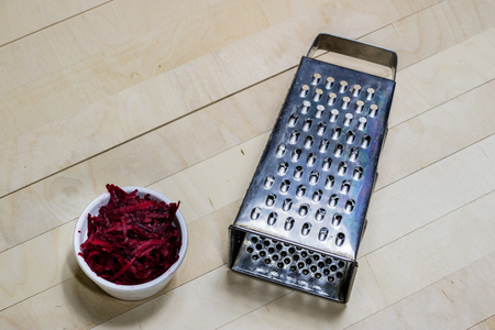 Beetroots grated on shavings. Wooden dining table. Black background.の写真素材