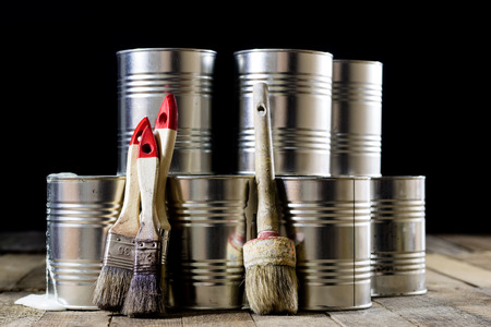 Cans of paint and brush on a wooden table. Painting with brushes.の写真素材