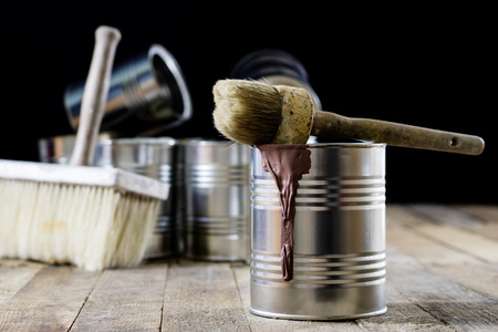 Cans of paint and brush on a wooden table. Painting with brushes.の写真素材