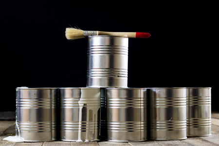 Cans of paint and brush on a wooden table. Painting with brushes.の写真素材
