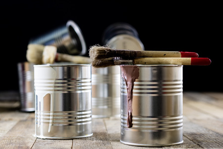 Cans of paint and brush on a wooden table. Painting with brushes.の写真素材