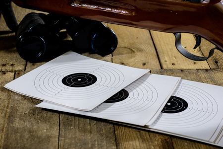 shooting, pneumatic and firearms on a wooden table. Table on the shooting range, weapons and shooting accessories. black backgroundの写真素材