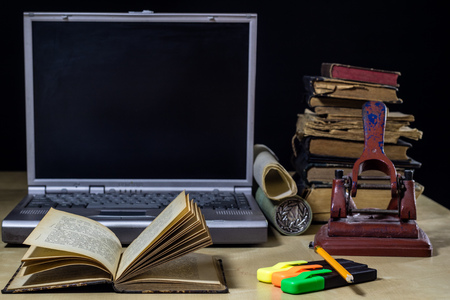 architect's table, laptop, calculator on the table. Plans, projects and notepad on the architect's table. Black background.の写真素材