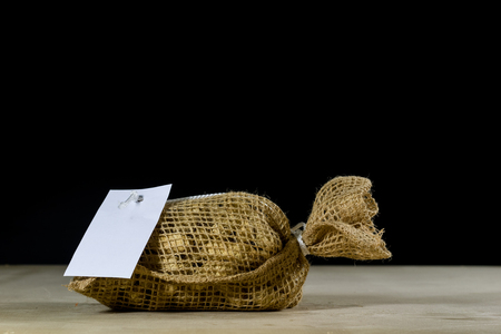 Fresh nuts in a jute bag on a wooden kitchen table. Italian hazelnuts in the kitchen before Christmas. Black backgroundの写真素材