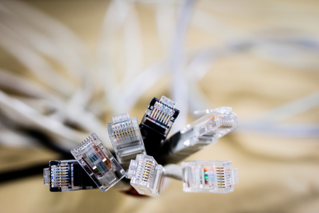 Rj45 cords on the stage. Computer accessories used in network connections. Black background.