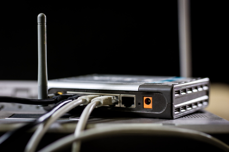 Network hub and rj45 cables on the stage. Computer accessories used in networking. Black background.の写真素材