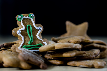 Tasty and delicious gingerbread cookies for Christmas. Christmas treats on the kitchen table. Black...