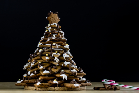 Tasty and delicious gingerbread cookies for Christmas. Christmas treats on the kitchen table. Black background.の写真素材