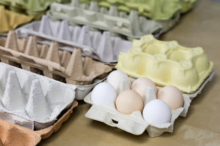 Eggs in molds on a wooden kitchen table. Hen egg in the kitchen atmosphere. black background