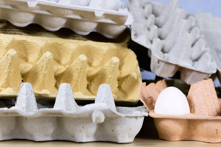 Eggs in molds on a wooden kitchen table. Hen egg in the kitchen atmosphere. black background