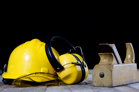 Carpentry is a hobby. Carpentry accessories on a wooden workshop table. Black background.の写真素材