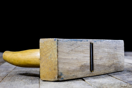 Carpentry is a hobby. Carpentry accessories on a wooden workshop table. Black background.の写真素材