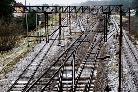 Old track at the railway station. Winter scenery of railway tracks with a passing train. Winter...