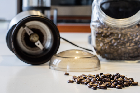 Morning coffee in the kitchen. Coffee grinder and coffee maker with coffee makers on a white kitchen table. Time of the day, morning.の写真素材
