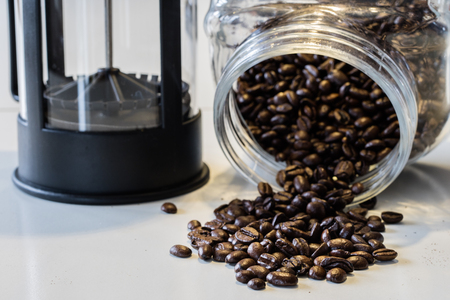 Morning coffee in the kitchen. Coffee grinder and coffee maker with coffee makers on a white kitchen table. Time of the day, morning.の写真素材