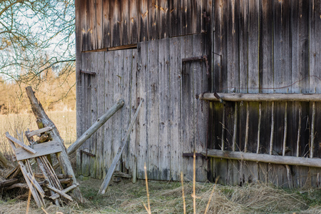 Old farm and wooden house, window, door in an old country house. Season of the early spring.の写真素材