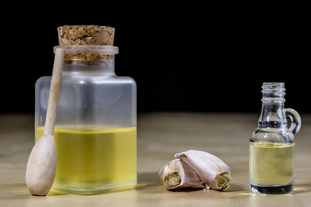 Garlic the best specific for influenza. Syrup prepared from healthy garlic. Black background.の写真素材