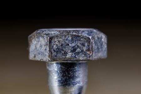 Bolts and screws for metal on a workshop table. Joinery accessories for furniture repair. Light...